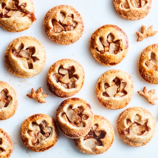 Mini apple pie cookies with a diced apple filling revealed through a windowpane crust.