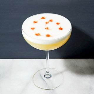 A pisco sour cocktail in a coupe glass.