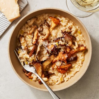 A bowl of risotto with wild mushrooms and Parmesan cheese.